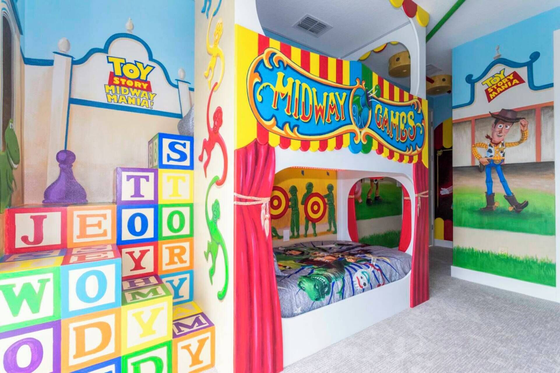 A children's playroom with a bunk bed, colorful alphabet blocks, and themed decorations.