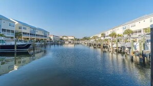 A marina with boats docked, waterfront buildings, and a calm water body. - Waterfront Townhome w/ Garage – St. Pete (St. Petersburg)