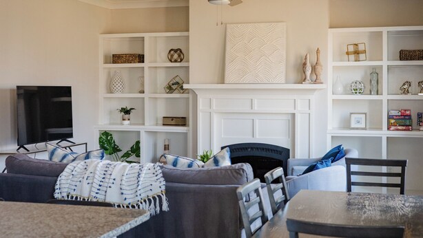 A living room with a fireplace, a television, and a dining area. - 4BR Nashville Stay w/ Pool Table & Patio! (Nashville)