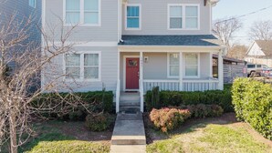 A two-story house with a red door, white trim, and a covered front porch. - 4BR Nashville Stay w/ Pool Table & Patio! (Nashville)