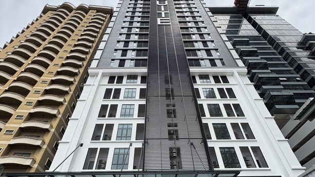 A modern hotel with a prominent entrance, large windows, and a distinctive facade. - The Suite by Manhattan Group (Kuala Lumpur)