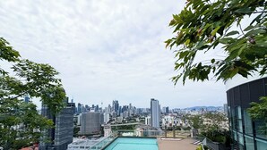 A rooftop pool with a city skyline view, lounge chairs, and modern architecture. - The Suite by Manhattan Group (Kuala Lumpur)