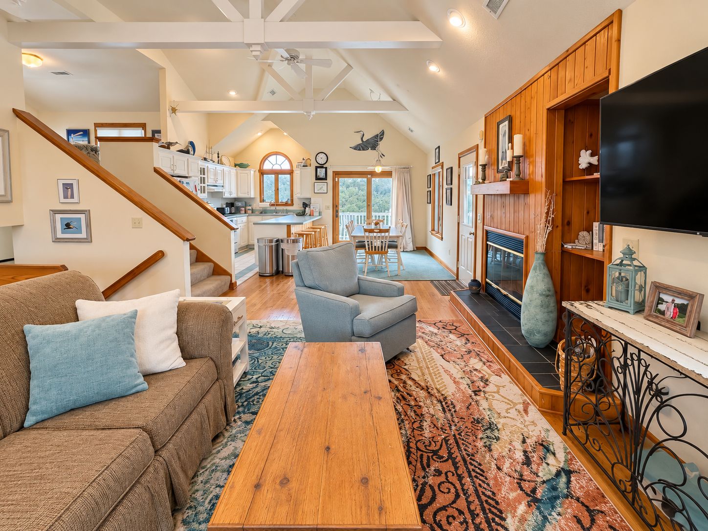 A spacious living area with a wooden coffee table, a sofa, and a fireplace.