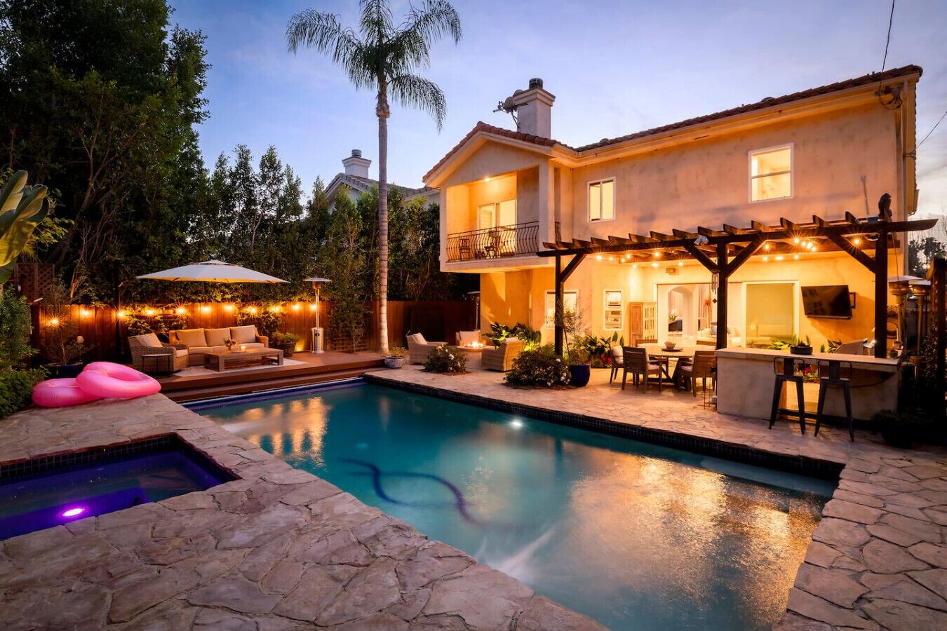 Dine al fresco beneath the covered patio and twinkling lights.