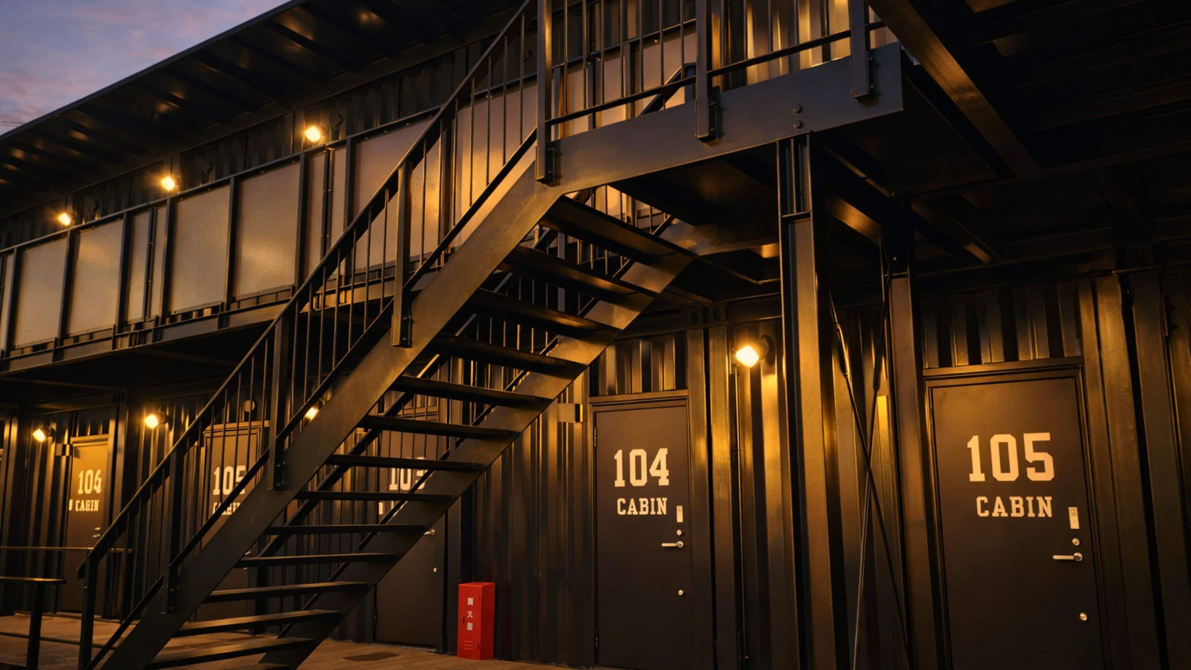 A building with a staircase leading to multiple cabins, each labeled with a number.