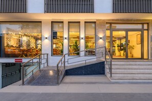 A hotel entrance with a staircase, a parking sign, and illuminated windows. - HOTEL MEERA PALACE (Varanasi)