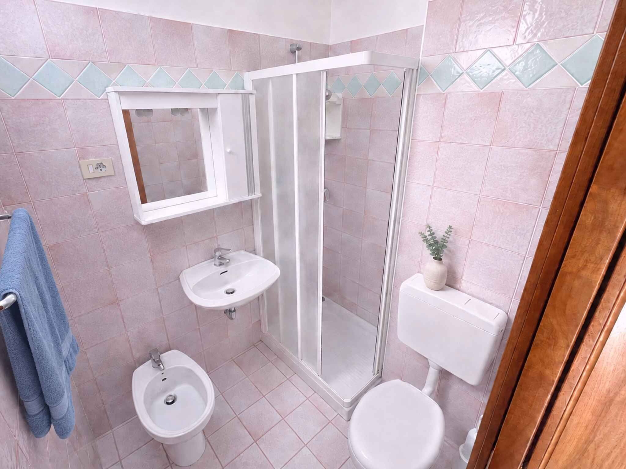 Une salle de bain avec une douche, deux lavabos, des toilettes et un miroir.