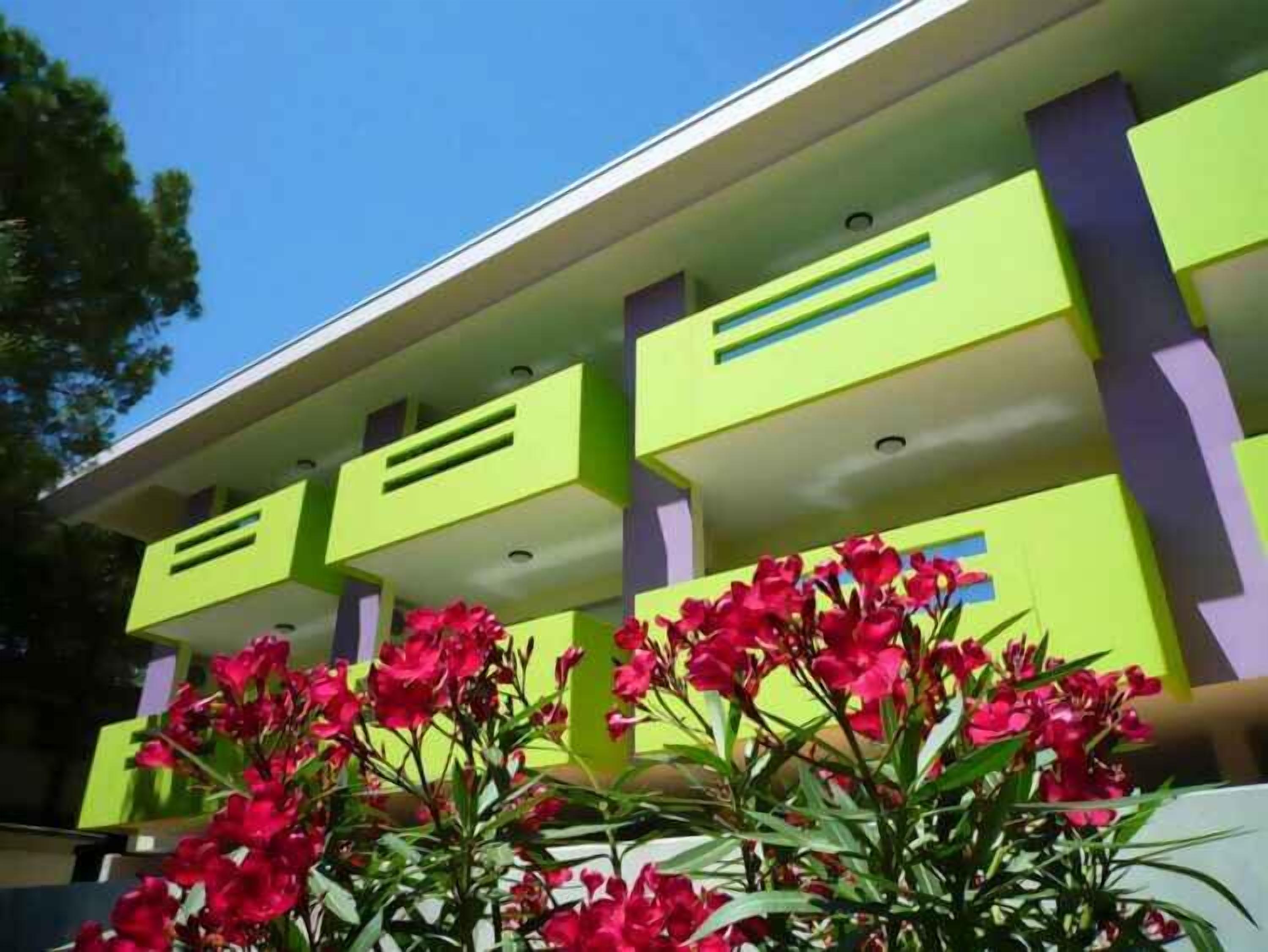 A modern building with a flat roof and a series of balconies.