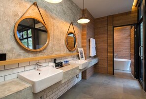 A modern bathroom with two sinks, wooden paneling, and a large mirror. - Wheeler Bed & Bike (Chonburi)