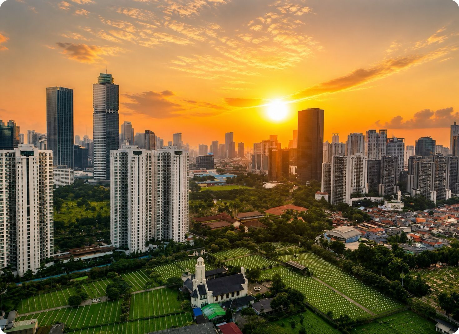 Un paisaje urbano con rascacielos, una iglesia y un cementerio al atardecer.