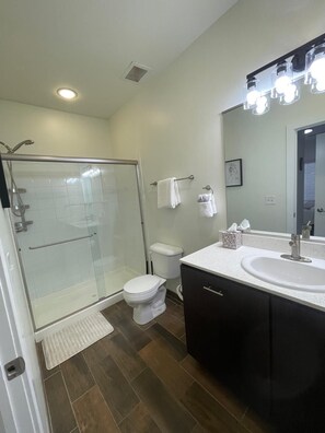 Shower, hair dryer, towels, shampoo