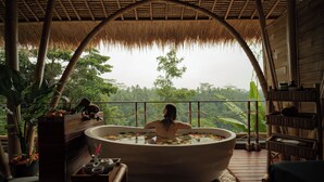 A person in a bathtub with a view of a lush landscape. - Marangga ubud valley view & private pool (Ubud)