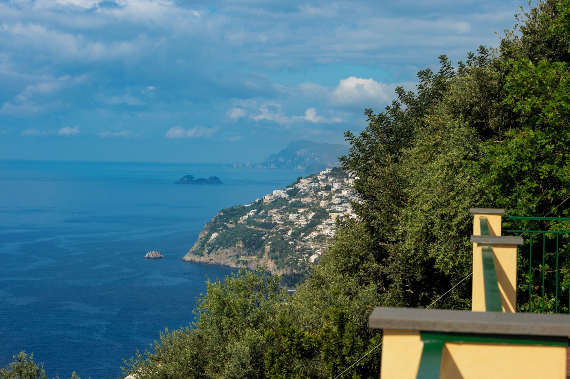 A coastal town with buildings on a hillside overlooking the sea.