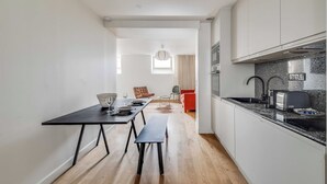 A modern kitchen with a black countertop, a built-in oven, and a sink. - Spacious Apartment  a/c 1BR/4P - Notre-Dame (Paris)