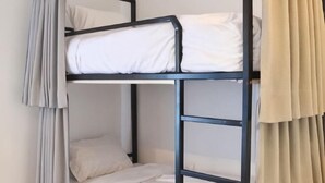 A bunk bed with white bedding and black metal frame. - Hide and Seek Hostel Vientiane (Thai Embassy) (Vientiane)