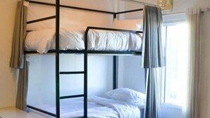 A bunk bed with a ladder, white bedding, and a window with curtains. - Hide and Seek Hostel Vientiane (Thai Embassy) (Vientiane)