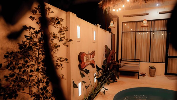 A pool area with a wooden deck, a sign reading "Chill", and a potted plant. - Chill Tangalle (Tangalle)