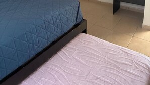 Ein Schlafzimmer mit einem Bett, einem Schminktisch und einem Regal.