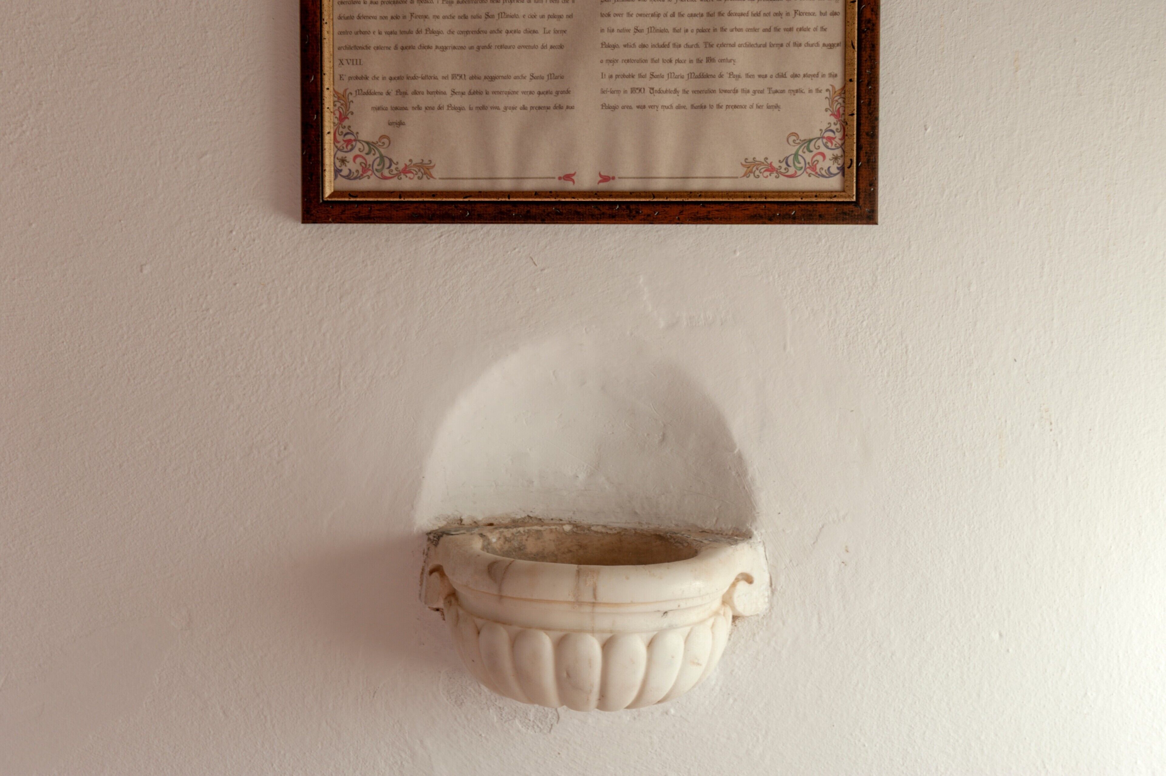 A framed document with text on a wall.