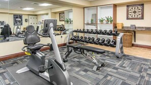 A gym with exercise equipment, including a treadmill, elliptical, and dumbbells. - Near Colonial Williamsburg, Busch Gardens, Historic Jamestown (Williamsburg)