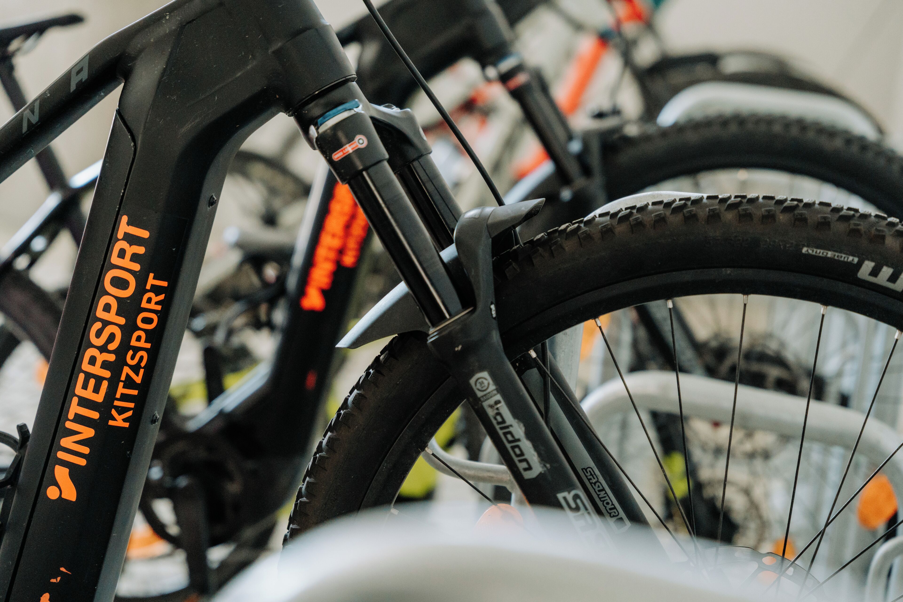 A close-up of a bicycle with 'INTERSPORT KITZSPORT' branding.