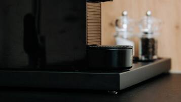 A coffee machine on a countertop with a wooden background.