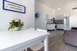 A modern kitchen with white cabinets, a built-in oven, and a stainless steel refrigerator. - Cozy apartment close Sorrento 1 BR up to 3 sleeps. Beach 10 min walking distance (Meta)
