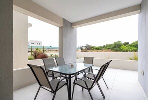 Outdoor dining - 2 bedroom ground floor apartment on the Mythical Seas complex with communal pool (Paralimni)