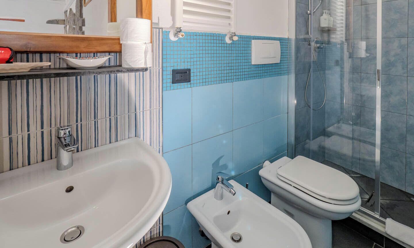 A bathroom with a sink, toilet, and shower.