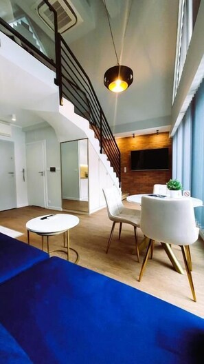 (305) Apartment with Mezzanine and Balcony | Living area | 55-inch Smart TV with cable channels