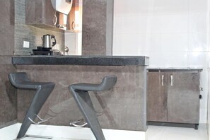 Deluxe Room, Balcony, City View | Private kitchen | Fridge, oven, stovetop, dishwasher - The Regal Boutique Hotel (Abuja)