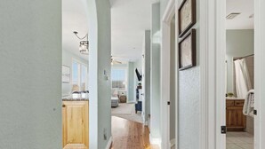 A hallway leading to a kitchen and bathroom with wooden flooring and light-colored walls. - Stone Cliff Oasis Scenic Views (Branson)
