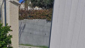 Un camí de formigó que condueix a un edifici amb façana blanca.
