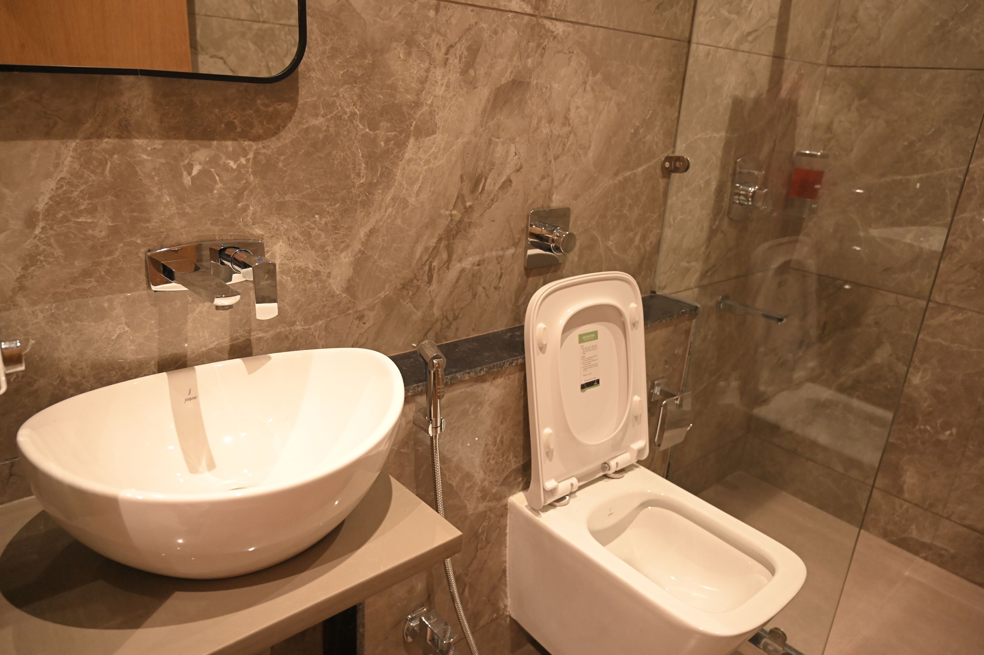 A bathroom with a white sink, a toilet, and a shower.