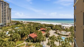 A resort with a pool, palm trees, and a beach view. - Inviting 2 Bedroom Condo in Westwinds at Sandestin Golf and Beach Resort (Miramar Beach)