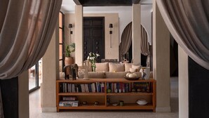 A living room with a sofa, bookshelves, a door, and curtains. - Villa Chocolat - Private pool - Perfect for relaxed  - (7 rms/14 Gst) (Marrakech)