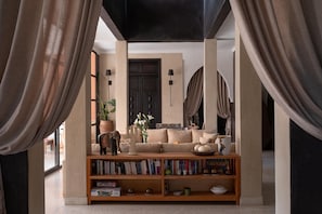 A living room with a sofa, bookshelves, a door, and curtains. - Villa Chocolat - Private pool - Perfect for relaxed  - (7 rms/14 Gst) (Marrakech)