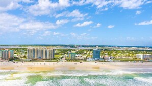 A coastal cityscape with a beachfront, high-rise buildings, and a clear sky. - Beach Studio With Partial Water Views Sundeck Pool (Daytona Beach Shores)