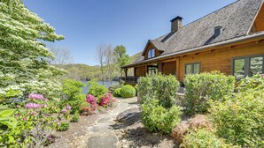 A wooden cabin with a stone pathway leading to a deck overlooking a lake. - 4 Mi to Bear Creek Lake! Serene Escape w/ Deck (Tuckasegee)