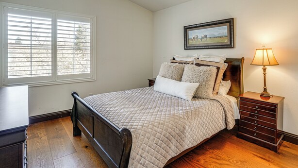 A bedroom with a bed, a nightstand with a lamp, a dresser, and a window with blinds. - Fairfield Wine Country Getaway w/ Backyard Oasis! (Fairfield)
