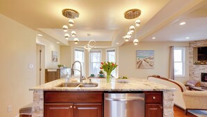 A modern kitchen with a central island, built-in dishwasher, and pendant lighting. - Walk to Kinnickinnic Ave! Newly Updated Abode (Milwaukee)