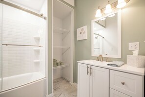 A bathroom with a walk-in shower, a vanity with a mirror, and a towel rack. - Shady Point Retreat w/ Hot Tub & Pickleball! (Killbuck)