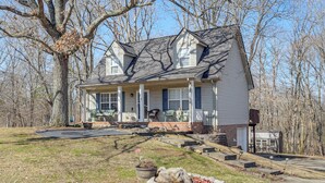 A two-story house with a front porch, a garage, and a small deck. - Private Patio! Studio 10 Mi to Dtwn Clarksville (Clarksville)