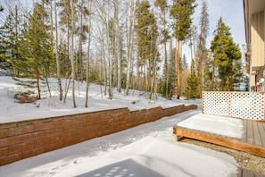 A snow-covered deck with a brick retaining wall and a wooden fence. - 3 Mi to Winter Park Slopes! Unit w/ Pool & Hot Tub (Winter Park)