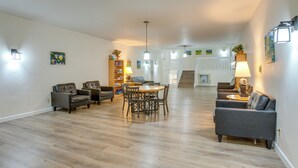 A spacious living room with a wooden floor, a dining table with chairs, and a sofa. - 3 Mi to Winter Park Slopes! Unit w/ Pool & Hot Tub (Winter Park)