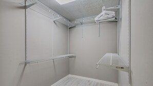 A storage closet with metal shelving units and a ceiling light fixture. - Peaceful Retreat w/ Private Hot Tub in New Albany (New Albany)
