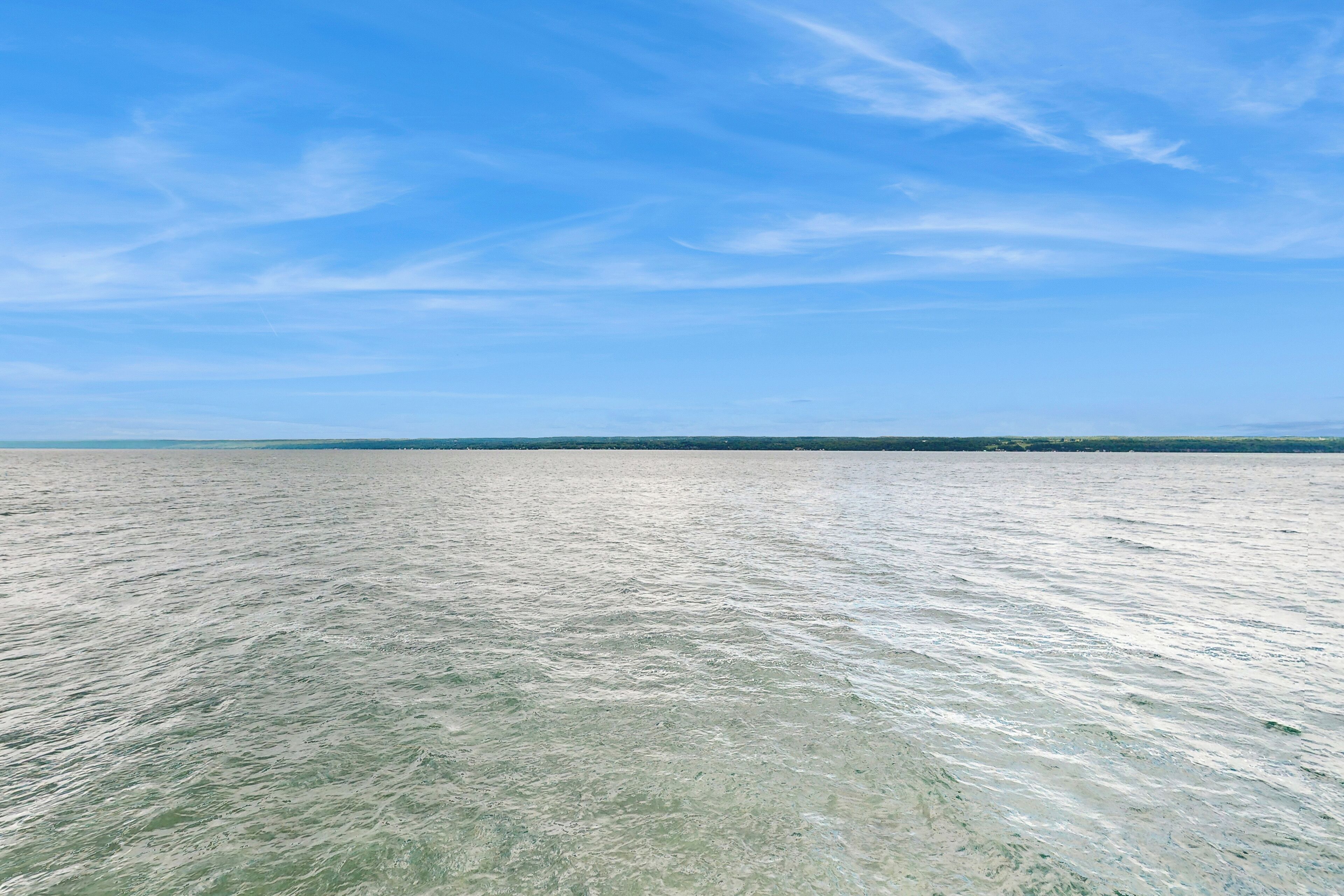 A wide view of a calm sea under a clear sky.