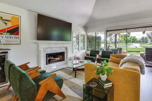 A modern living room with a fireplace, comfortable seating, and a large TV. - Palm Desert Gem w/ Outdoor Oasis & Resort Perks! (Palm Desert)