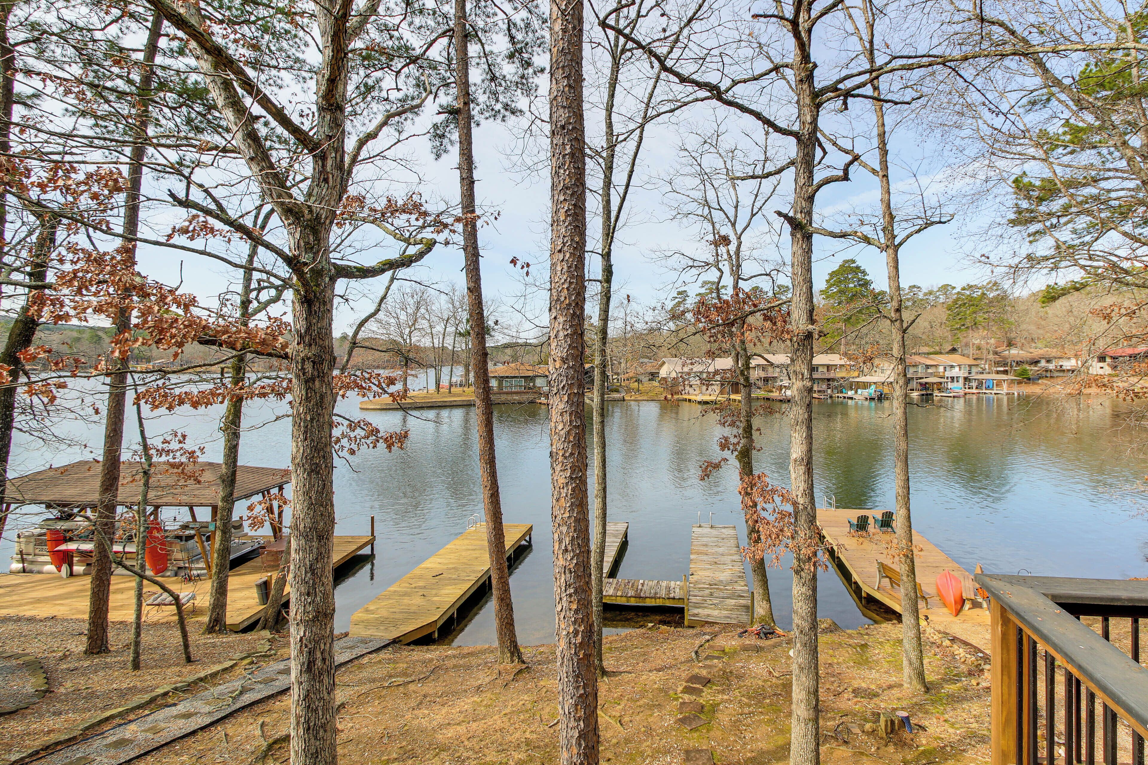 A lakeside view with wooden docks and a covered seating area.
