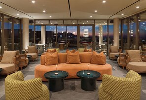 A modern lounge area with a sofa, armchairs, and a coffee table. - NALU Latchi Leonardo Limited Edition (Polis)
